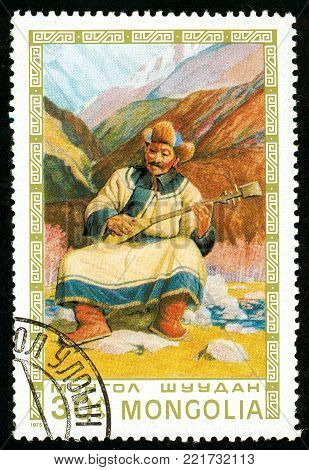 Ukraine - circa 2018: A postage stamp printed in Mongolia shows Man playing lute. Series: Mongolian paintings masterfully. Circa 1975.