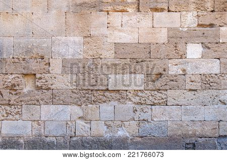 Yellow castle rugh pattern stone block from ancient structure texture