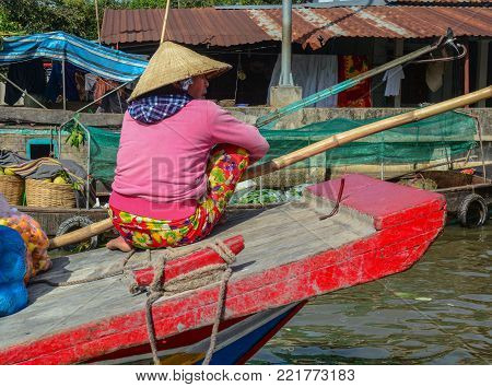 Soc Trang, Vietnam - Feb 2, 2016. People with boats at a floating market on Mekong River in Soc Trang, Vietnam. Mekong is the longest river in Southeast Asia, the 7th longest in Asia.