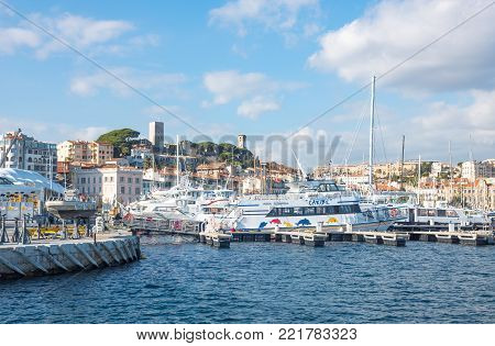Cannes, France - November 21, 2017: luxury boats in the marina with Le Sequet old town in tha background