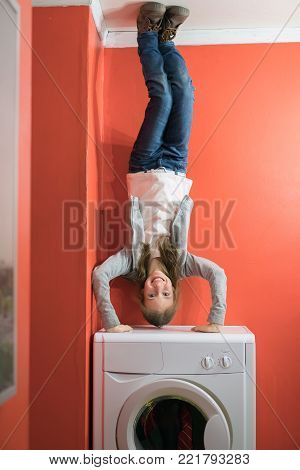 Upside Down House. Little Girl On The Washing Machine.