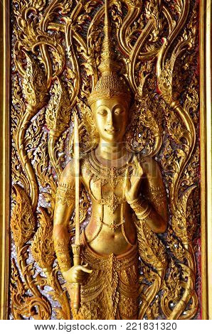 Carving and sculpture angel thai style on the door of church or ubosot of Wat Tha Sung or Wat Chantharam temple in Uthai Thani, Thailand