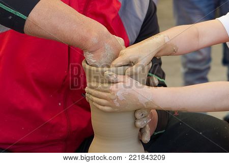 close up of hand making ceramic pottery