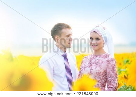 Islamic wedding ceremony. Malay wedding couple in sunflowers.