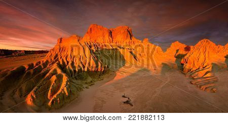 Setting Sun Over Red Top In Australian Outback