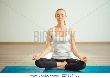 Young woman meditates while practicing yoga. Freedom concept