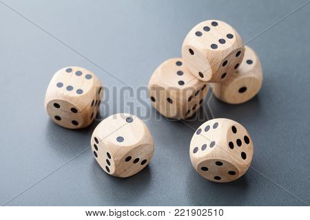 Wooden dice on gray table. Board game. Gambling devices.