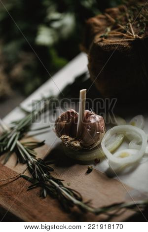 Garlic with pranami spices and herbs, onion and garlic. Healthy Food photo for recipe or cookbook. Wooden black backround.