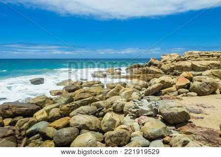 Rocky ocean waves summer blue  landscape along scenic summer coastline.
