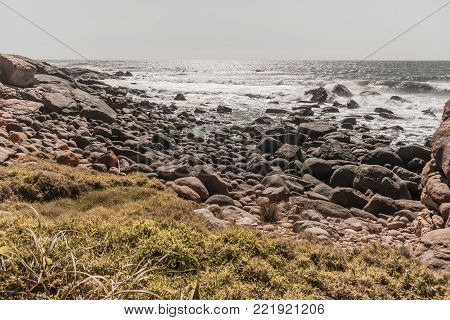 Rocky coastline ocean  waves crashing along summer beach vintage tone landscape .
