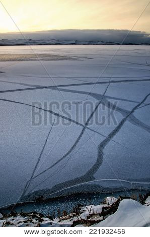 View above big beautiful frozen lake and mountain in winter, Baikal lake, Russia, Siberia
