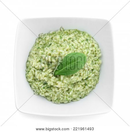 Dish with tasty spinach risotto on white background