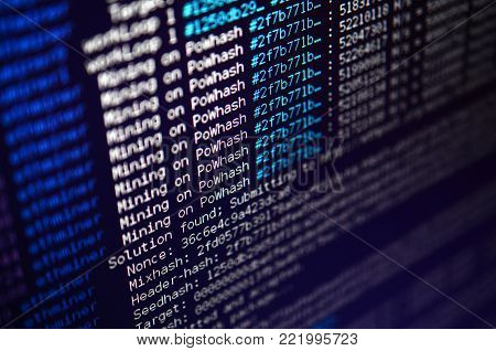 Macro snapshot of the program interface for crypto currency mining on the monitor of an office computer. The concept of mining bitcoins. The flow of information strings and data