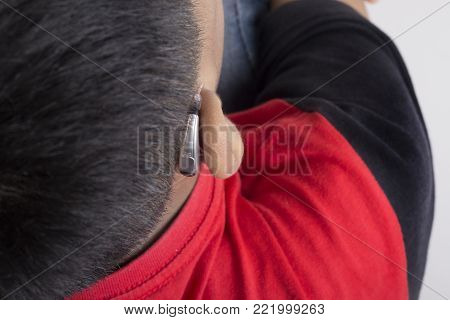 A Male Patient Using Mini Behind The Ear Hearing Aid.