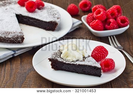 Piece Of Chocolate Sticky Brownie Cake, Swedish Dessert Kladdkaka, On The Plate, Garnished With Icin