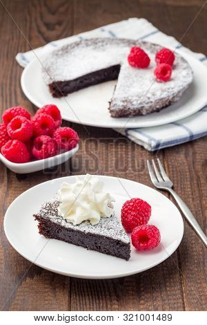 Piece Of Chocolate Sticky Brownie Cake, Swedish Dessert Kladdkaka, On The Plate, Garnished With Icin