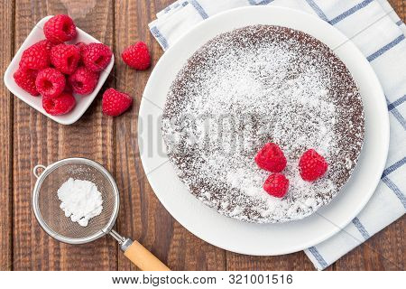 Chocolate Sticky Brownie Cake, Swedish Dessert Kladdkaka, On The Plate, Garnished With Icing Sugar A