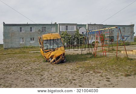 Yellow Damaged Van In Russian Village Teriberka