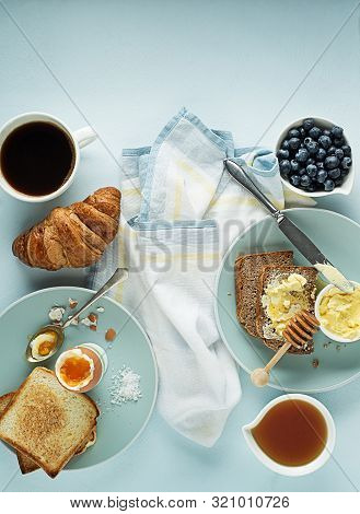Breakfast Served With Coffee, Croissant, Egg, Bread, Honey And Butter. Delicious Healthy Breakfast.