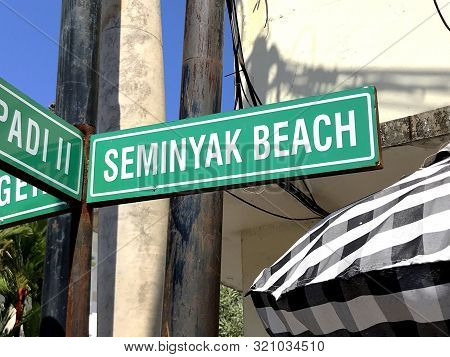 Seminyak, Bali, Indonesia - August 14, 2018: Green Seminyak Beach Direction Sign.