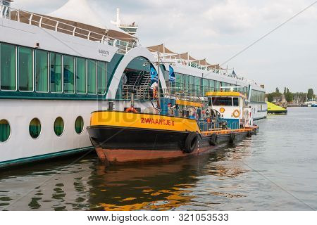 Amsterdam, The Netherlands - August 21 2019: Rhine River Cruise Ship Being Refueled By A Fuel Boat I
