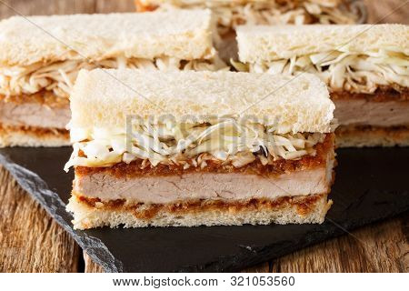 Japanese Fast Food Katsu Sando Sandwiches With Tonkatsu Sauce And Cabbage Closeup On A Slate Board.