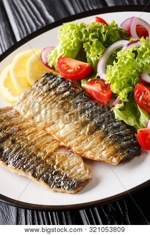 Grilled Mackerel Fillet With Fresh Salad And Lemon Close-up On A Plate. Vertical