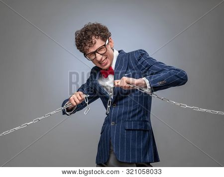 Funny Businessman Breaking The Chain By Hands For Liberation As A Symbol Of Work Captivity