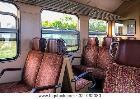 Interior Of Old European Train With Chairs In Red Colors