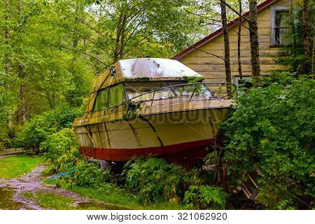 Abandoned Boat In The Woods By The Shoreline