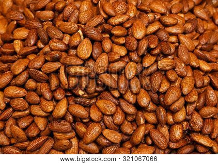 Group Of Freshly Roasted Tasty Almonds Background Image