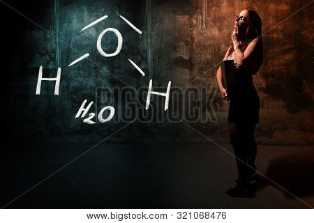 Sexy Girl Or Secretary Or Female Student Presenting Handdrawn Chemical Formula Of H2O Water