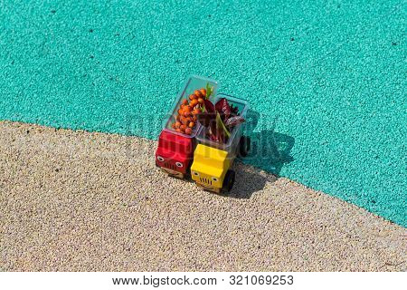 Two Toy Cars Trucks Brought Autumn With Them. In The Back Are Red Leaves And Rowan Berries. Copy Spa