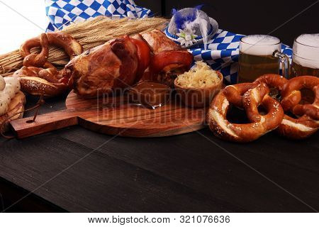 Traditional German Cuisine, Schweinshaxe Roasted Ham Hock. Beer, Pretzels And Various Bavarian Speci