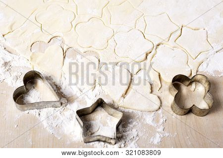 Cooking Cookies In The Shape Of A Heart, Star And Flower On A White Wooden Table.