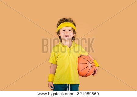 Little Basketballer. Child Boy In Sportswear Holds Ball. Basketball Player With Ball. Cute Boy Holds