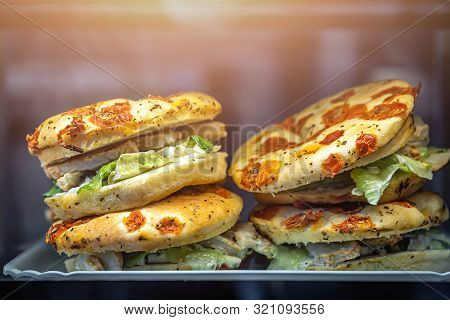Chicken, Salad And Sundried Tomatoes Focaccia Sandwiches For Sale On Display In A Cafe In Airport Lo