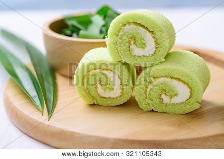 Pandan Roll Cake And Fresh Pandan Leaf On Wooden