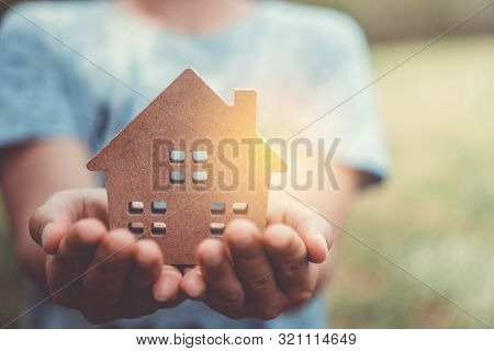 Copyspace Model Of A Little House That Woman Holds It Background.