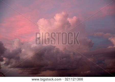 Dramatic pink smoke vening sky with clouds.