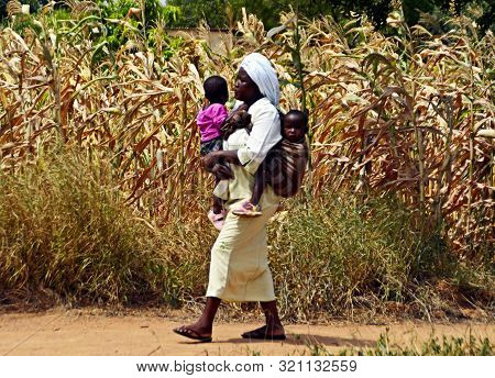 Mombasa / Kenya, Africa - 25 January, 2018: African Woman Walking With Children In The Village Near 