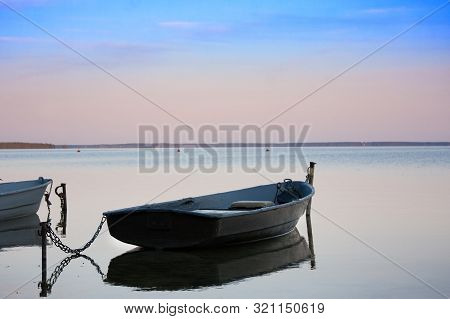 Old Fishing Boats With Chain On Lake At Sunset In Summer