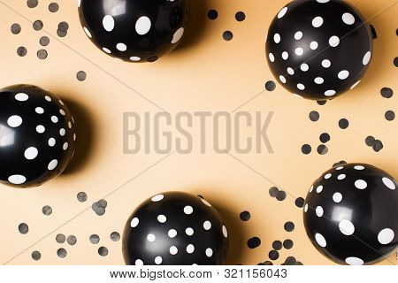Halloween Party Flat Lay With Black Balloon And Confetti On Biege Background, Holiday And Black Frid