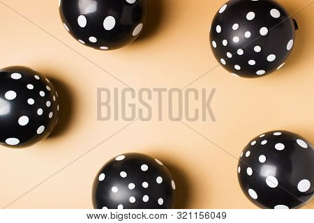 Halloween Party Flat Lay With Black Balloon And Confetti On Biege Background, Holiday And Black Frid