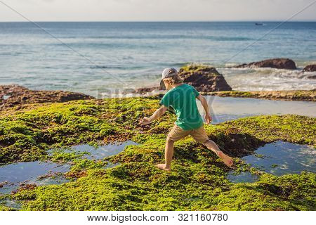Boy Tourist On Pantai Tegal Wangi Beach, Bali Island, Indonesia. Bali Travel Concept. Traveling With