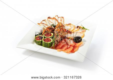 Fish platter with pink salmon, grilled eel, oil fish balyk and red caviar on elegant restaurant plate isolated on white background. Exquisite serving thin slices of salted and dried delicious seafood