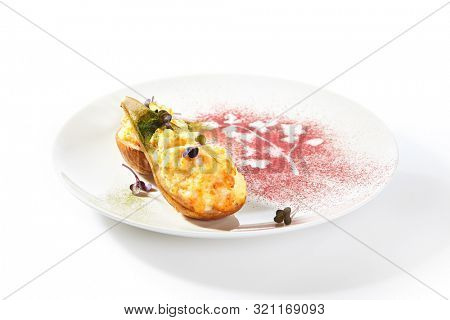 Pear baked with cheese isolated on white background, gourmet restaurant dessert. Roasted halves of pears, cheesy delicious fruit autumn dish cut out