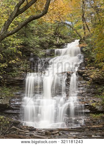 Tall Waterfall In Pennsylvania In Fall Foliage Colors With Silky Flowing Water.