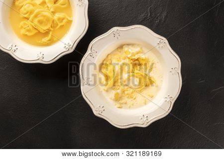 Tortellini Served With Broth And Cream Sauce, Italian Food On A Black Background