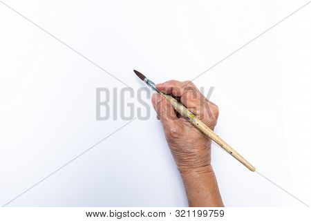 Senior Woman's Hand Painting With Paintbrush Isolated On White Background